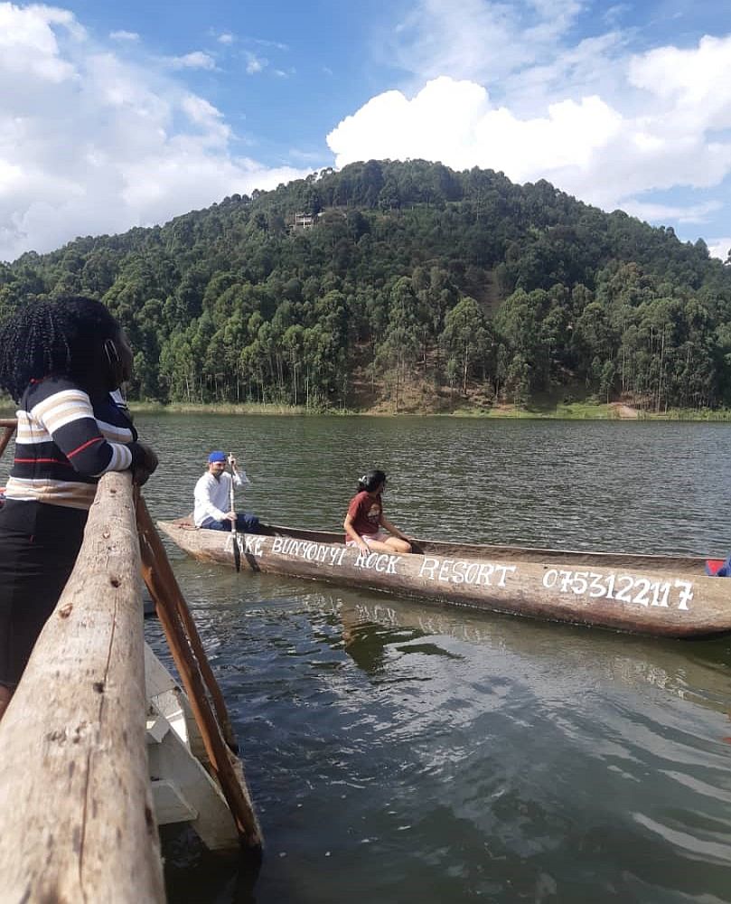 tourists enjoy a g=dugout canoe ride at Lake Bunyonyi