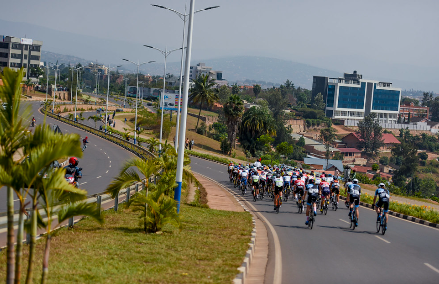 Cyclists riding through Kigali's city center, showcasing Rwanda's infrastructure and scenery - Best Rwanda Travel Tips